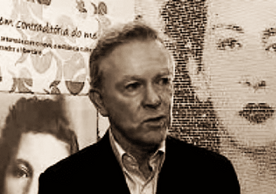 K. David Jackson speaking in front of background images of Patrícia Galvão (Pagu)